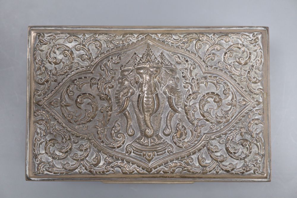 Three Thai white metal cigarette boxes, largest 16.1cm.